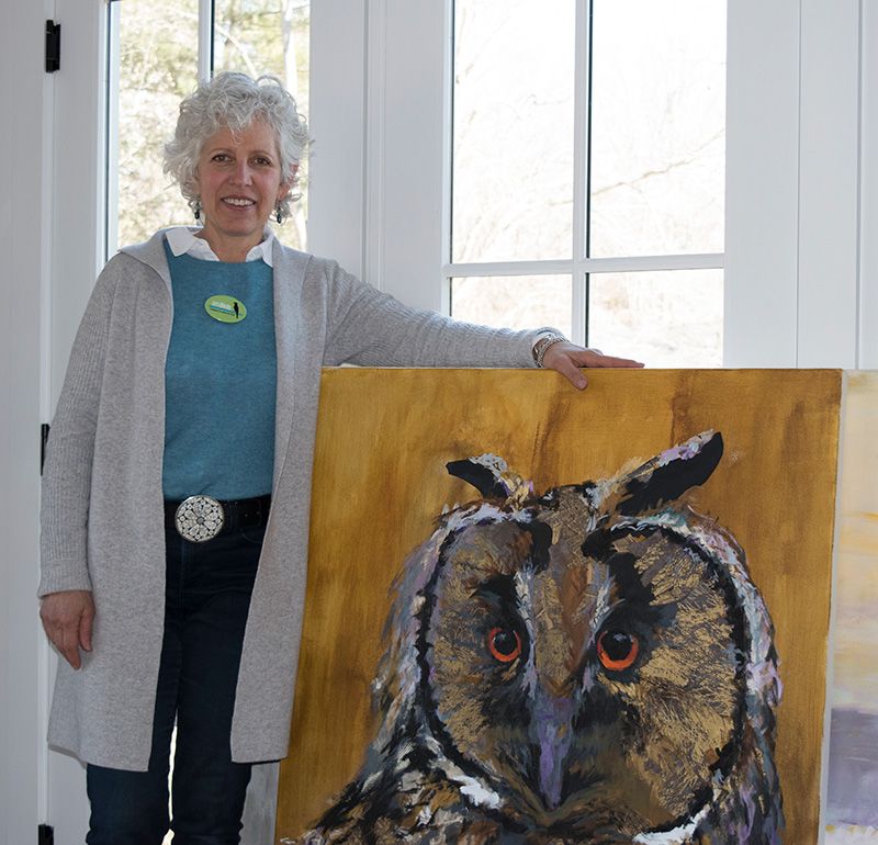 Karen Kent holding ‘Joia’ a 48” x 36” mixed media painting
