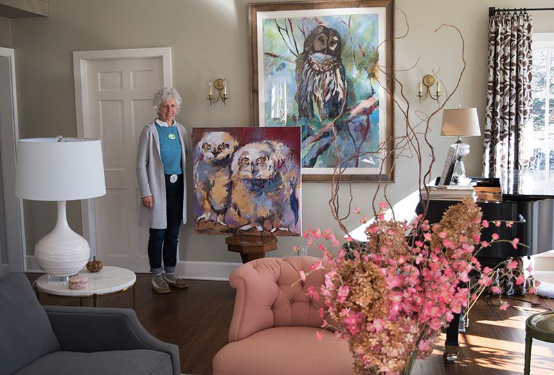 Karen with two of her favorite paintings - Charlie and Herb and Glo