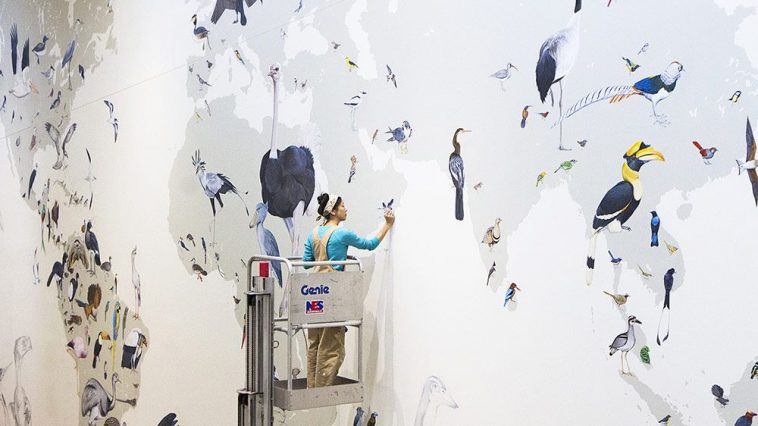 Painting the Wall of Birds mural at the Cornell Lab of Ornithology. Photo by Shailee Shah
