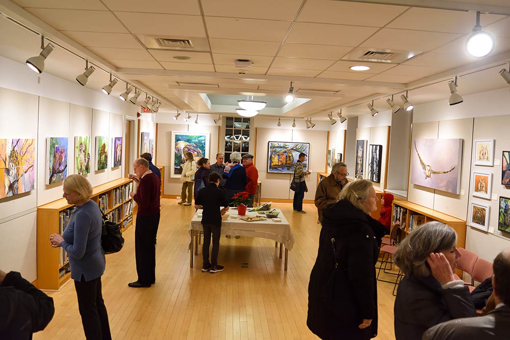 Crowd enjoying Karen Kent’s Latest Owl Series on Exhibit at the New Canaan Library
